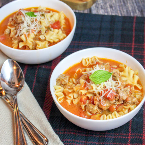 White bowl of soup on a plaid background