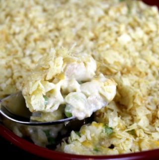 Pasta shells topped with potato chips scooped from a casserole dish