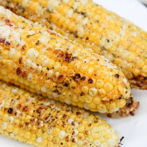 grilled corn stacked on a plate