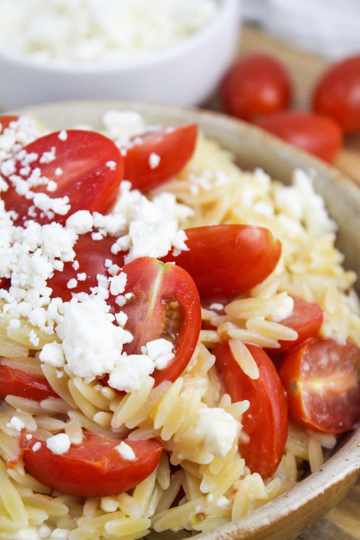 greek orzo with tomatoes and feta in a bowl