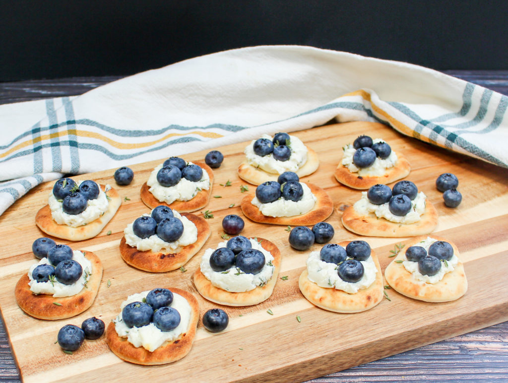 Naan with blueberries on a cutting board