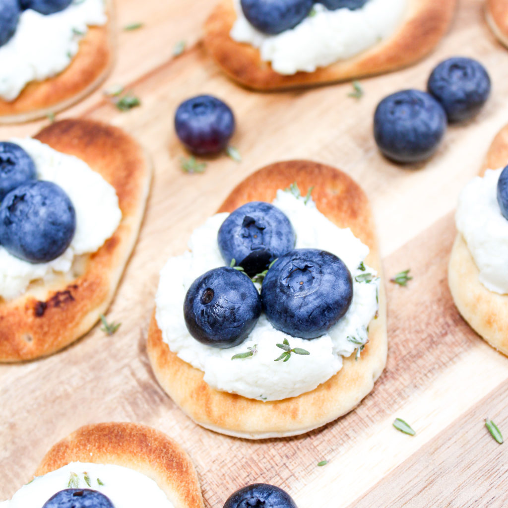 Naan with blueberries on a cutting board