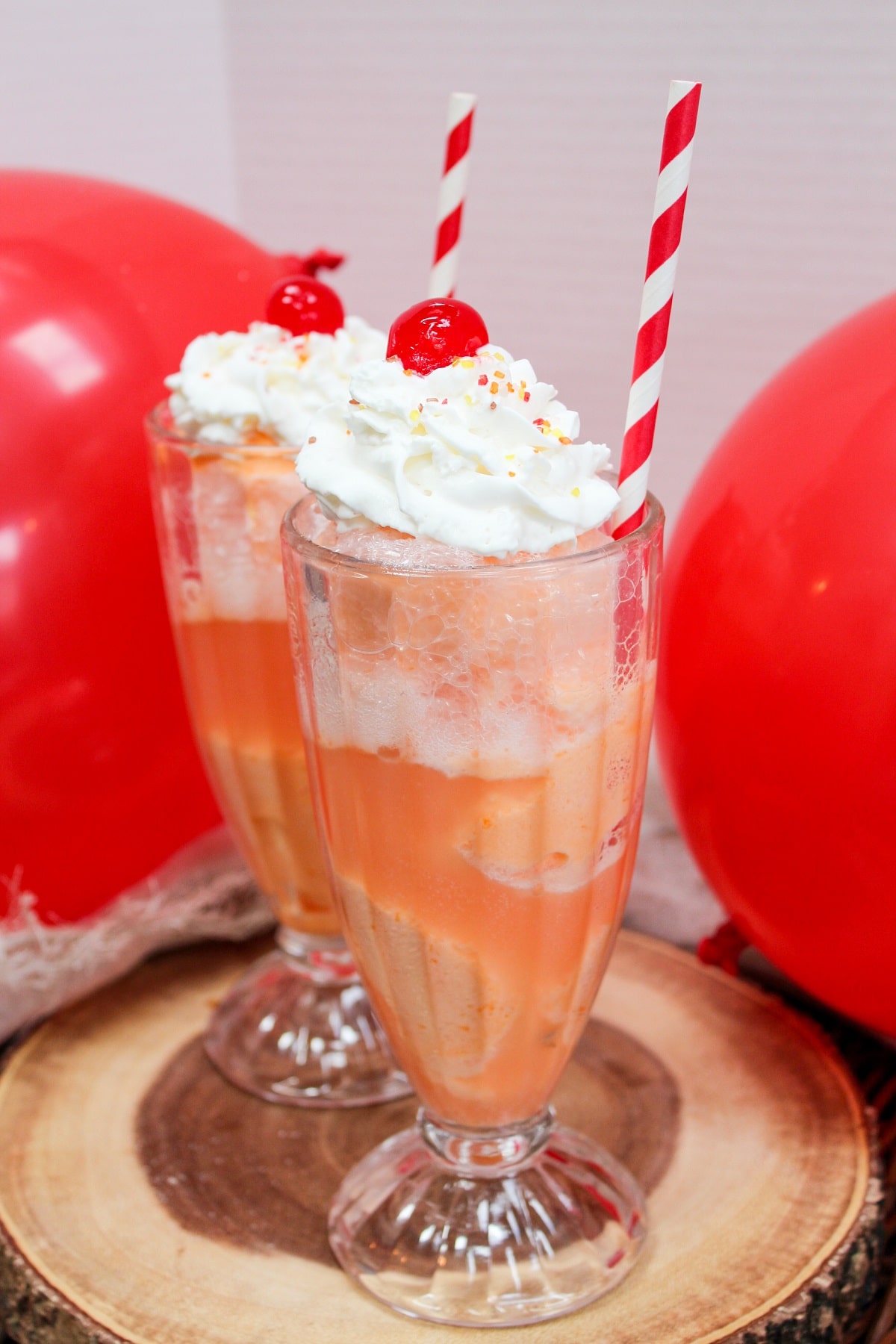 ice cream float in a glass with whipped cream and a cherry