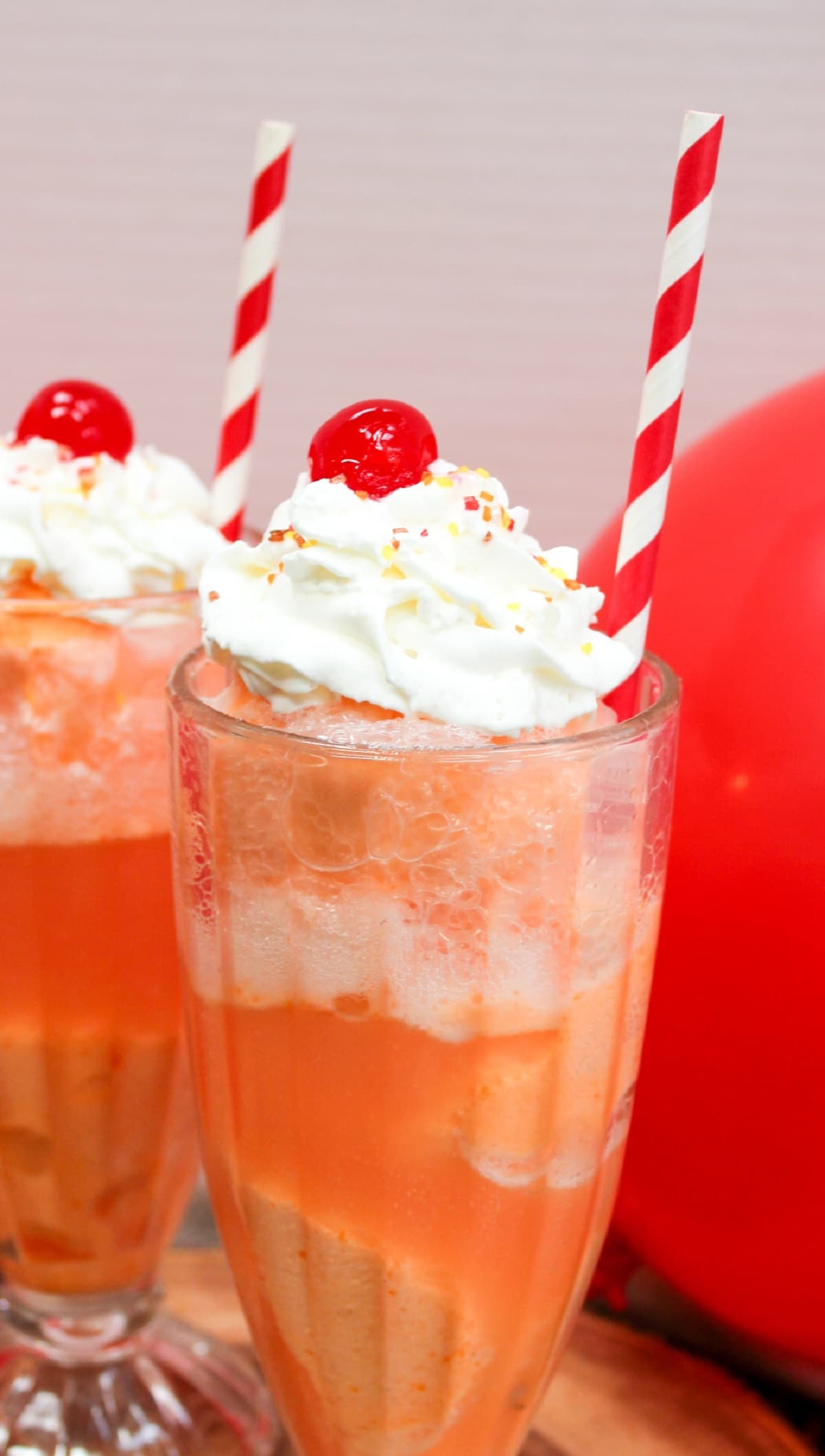 ice cream float in a glass with whipped cream and a cherry