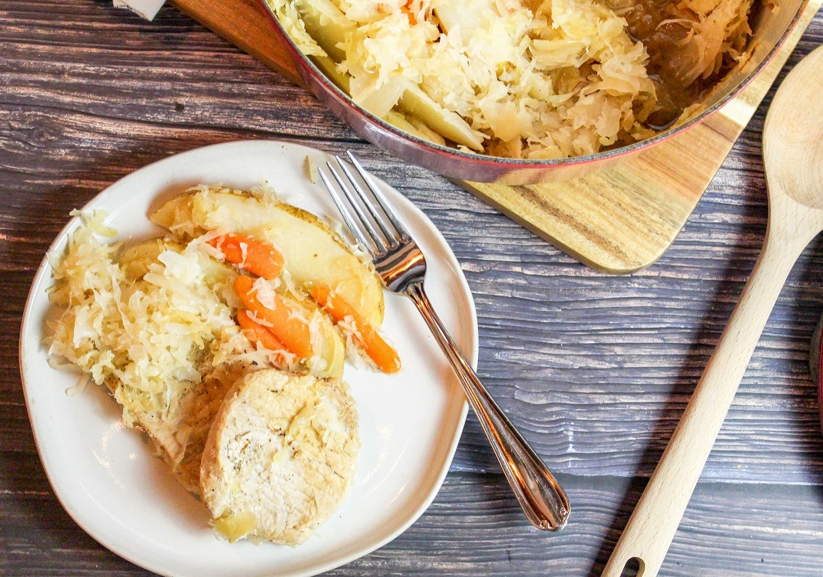 pork chops with sauerkraut on a plate with a fork