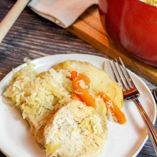 pork chops with sauerkraut on a plate with a fork