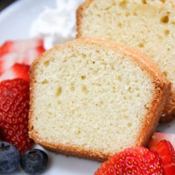 mini pound cake sliced with berries on a plate