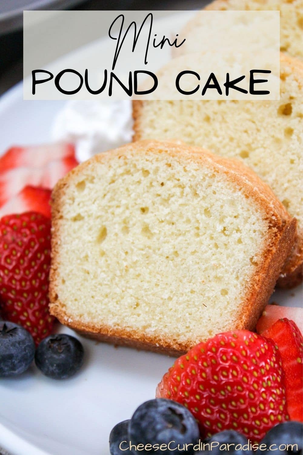 mini pound cake sliced with berries on a plate