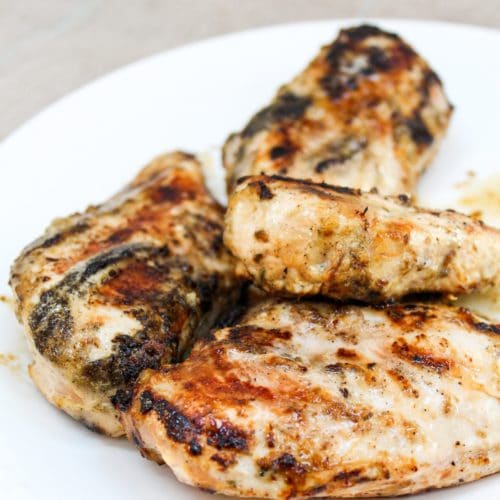 grilled lemon pepper chicken on white plate