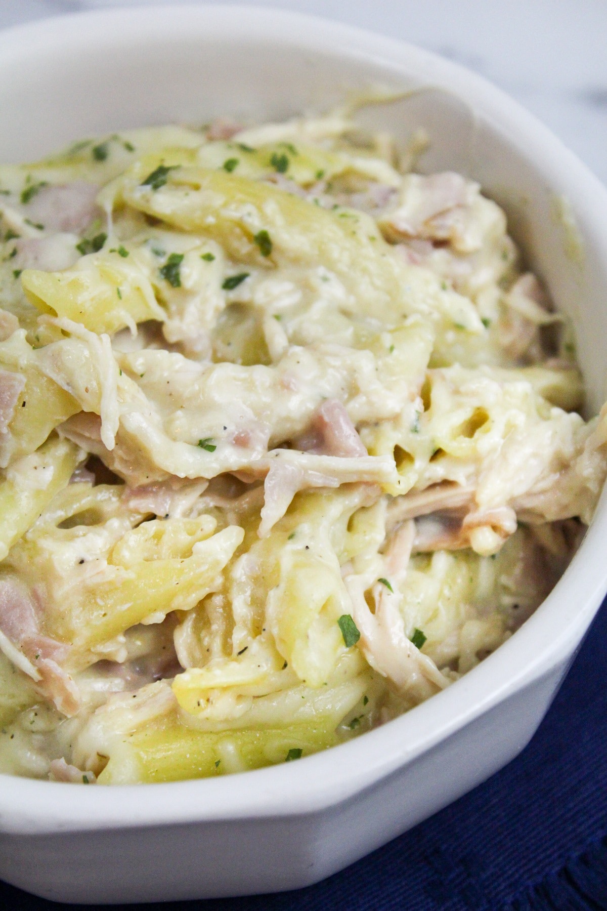 chicken cordon bleu pasta in a white bowl