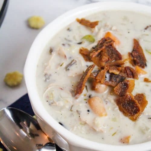 chicken and rice soup with bacon in a white bowl