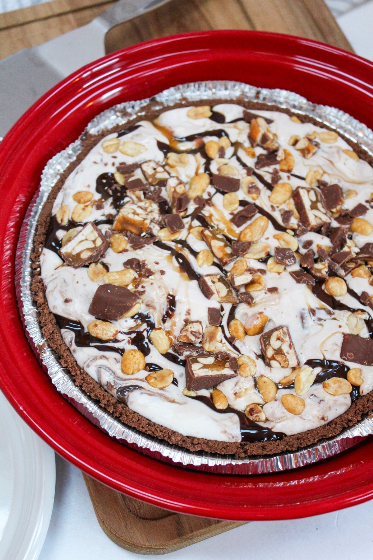 Snickers Ice Cream Cake in a red pie dish.