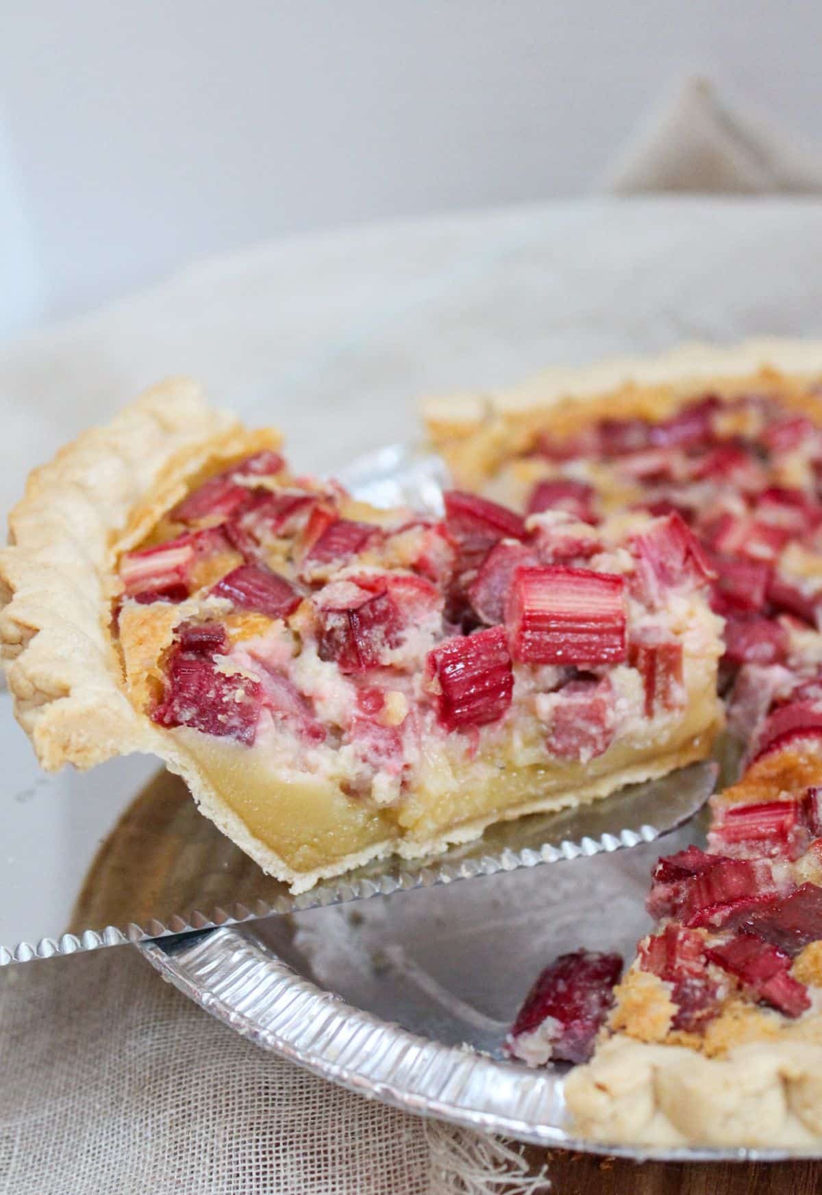 Slice of pie take from the pan with a silver server.