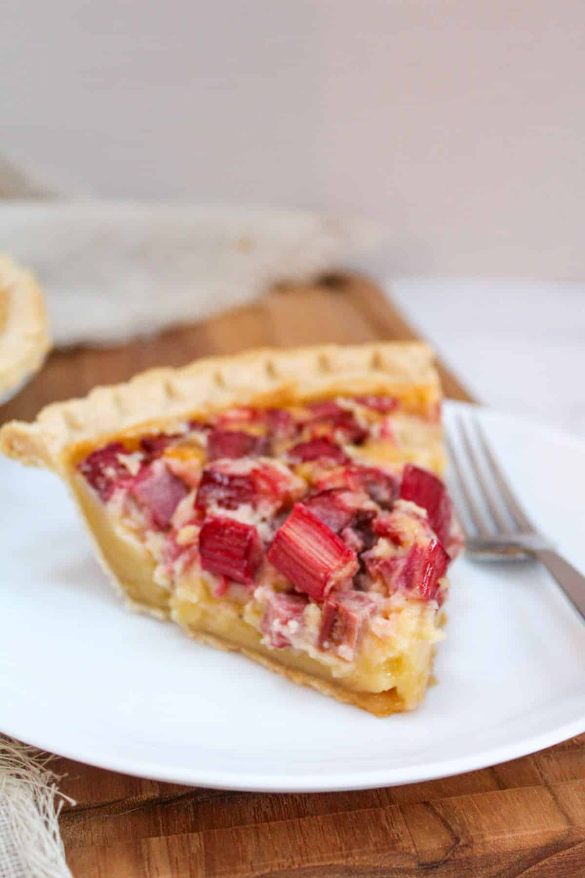 Rhubarb Custard Pie on a plate with a fork.